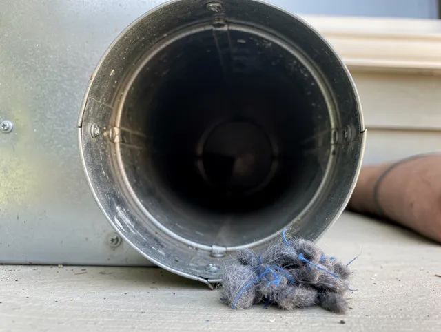 Pine Hills Dryer Vent Cleaning technician using specialized equipment to clear severe dryer vent blockage in Pine Hills